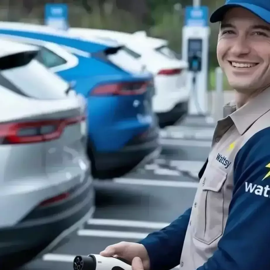 happy person charging electrical vehicle